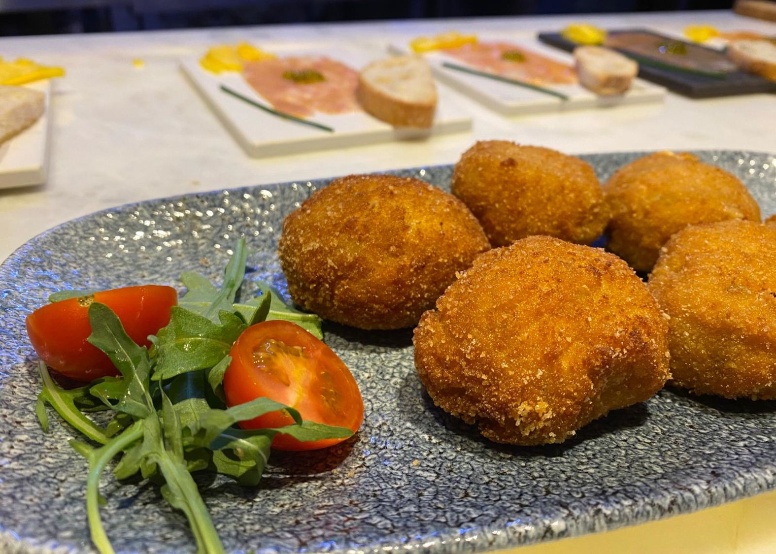 Croquettes with a cherry tomato cutted in half
